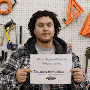A slide show of pre-apprentice trainees holding signs