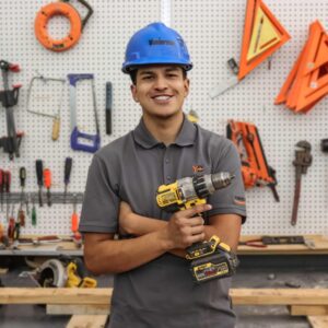 Pre-Apprentice Trainee Jaime posing in front of tools