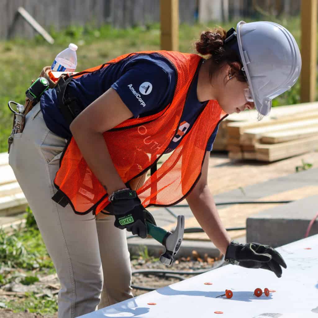 girl working wearing a hard hat