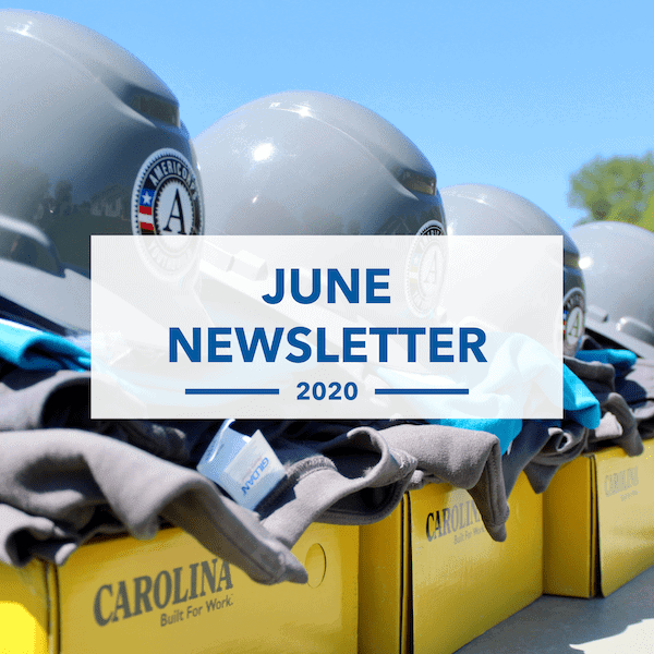 Several gray hard hats with the AmeriCorps logo rest on boxes labeled CAROLINA outdoors. Overlaid text reads June Newsletter 2020. Shirts are folded beneath the helmets.