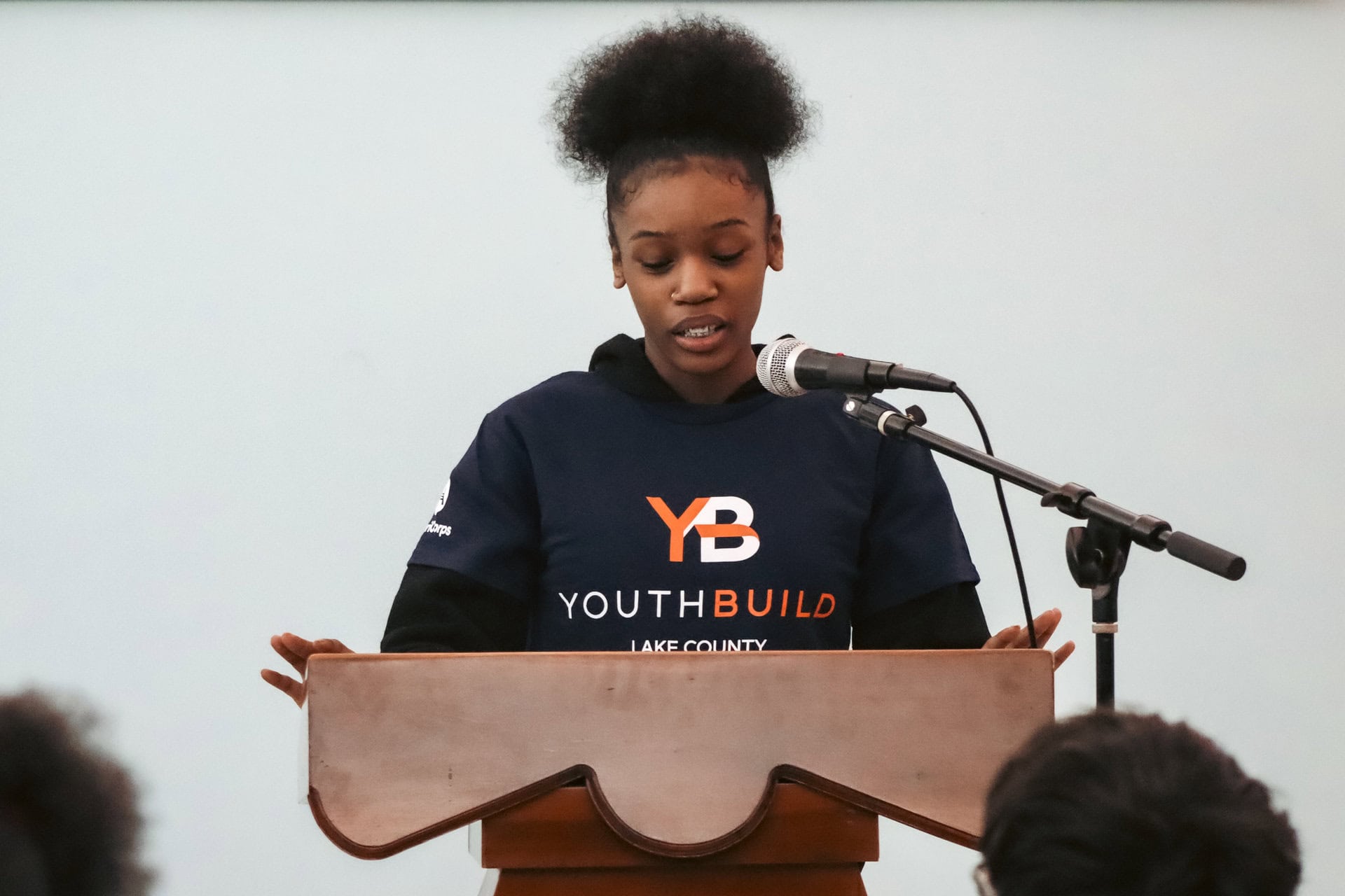 Young woman on a podium doing a speech 